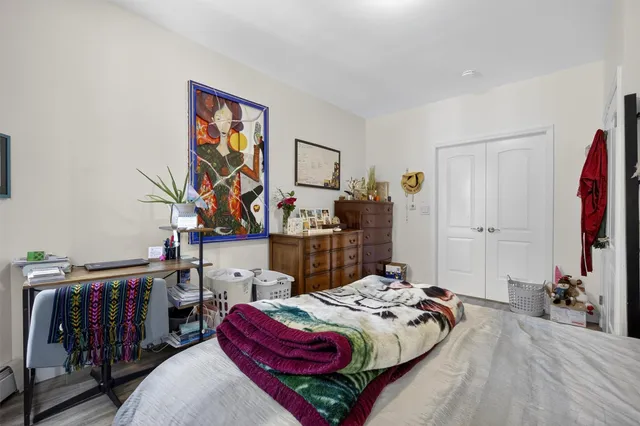 a bedroom with a bed and a closet