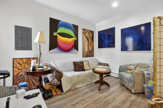 a living room with furniture and painting on the wall