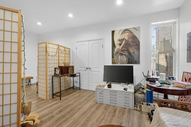 a view of a workspace with furniture and a flat screen tv