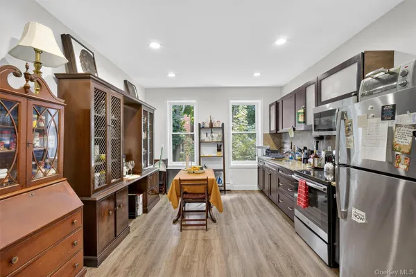 a view of a kitchen with stainless steel appliances granite countertop a stove and a refrigerator