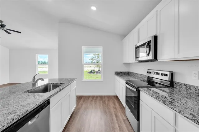a kitchen that has a sink and a stove