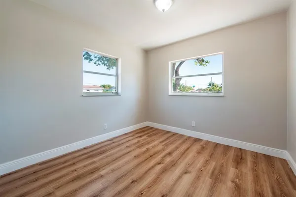 a view of room with window and wooden floor