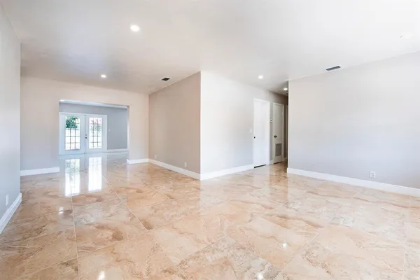 a view of an empty room and a window