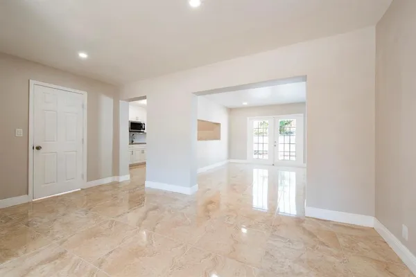 an empty room with windows and closet