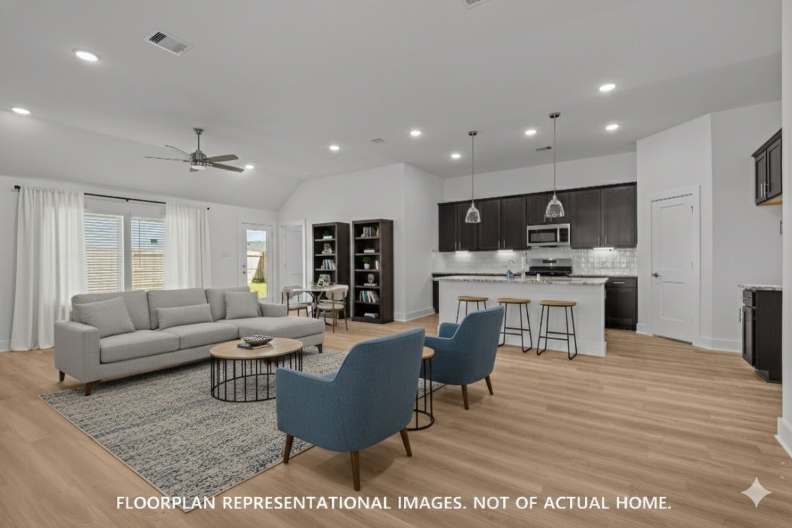 1815 Sleeping Hls Drive Rosenberg, TX 77471 - Photo 6 of 12 a living room with furniture a kitchen view and a wooden floor