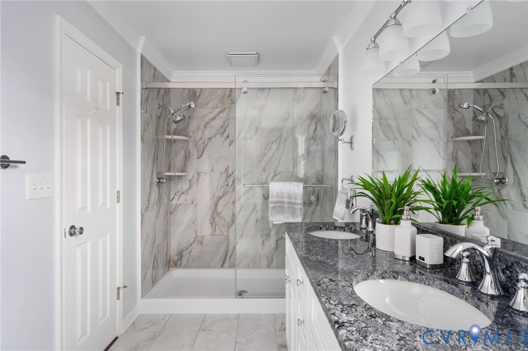 16379 Arch Hill Road Hanover, VA 23069 - Photo 20 of 26 a bathroom with a granite countertop shower a mirror and a sink