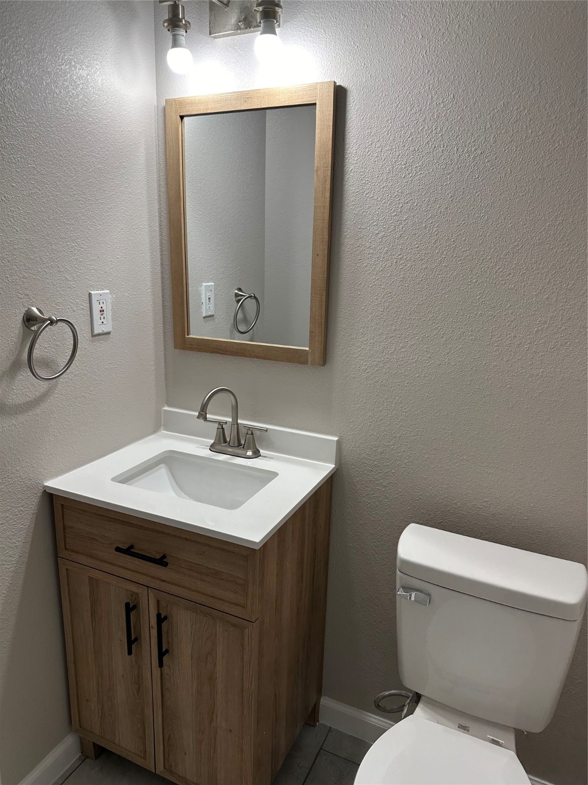 2922 Randolph Road Pasadena, TX 77503 - Photo 12 of 50 a bathroom with a toilet sink and mirror