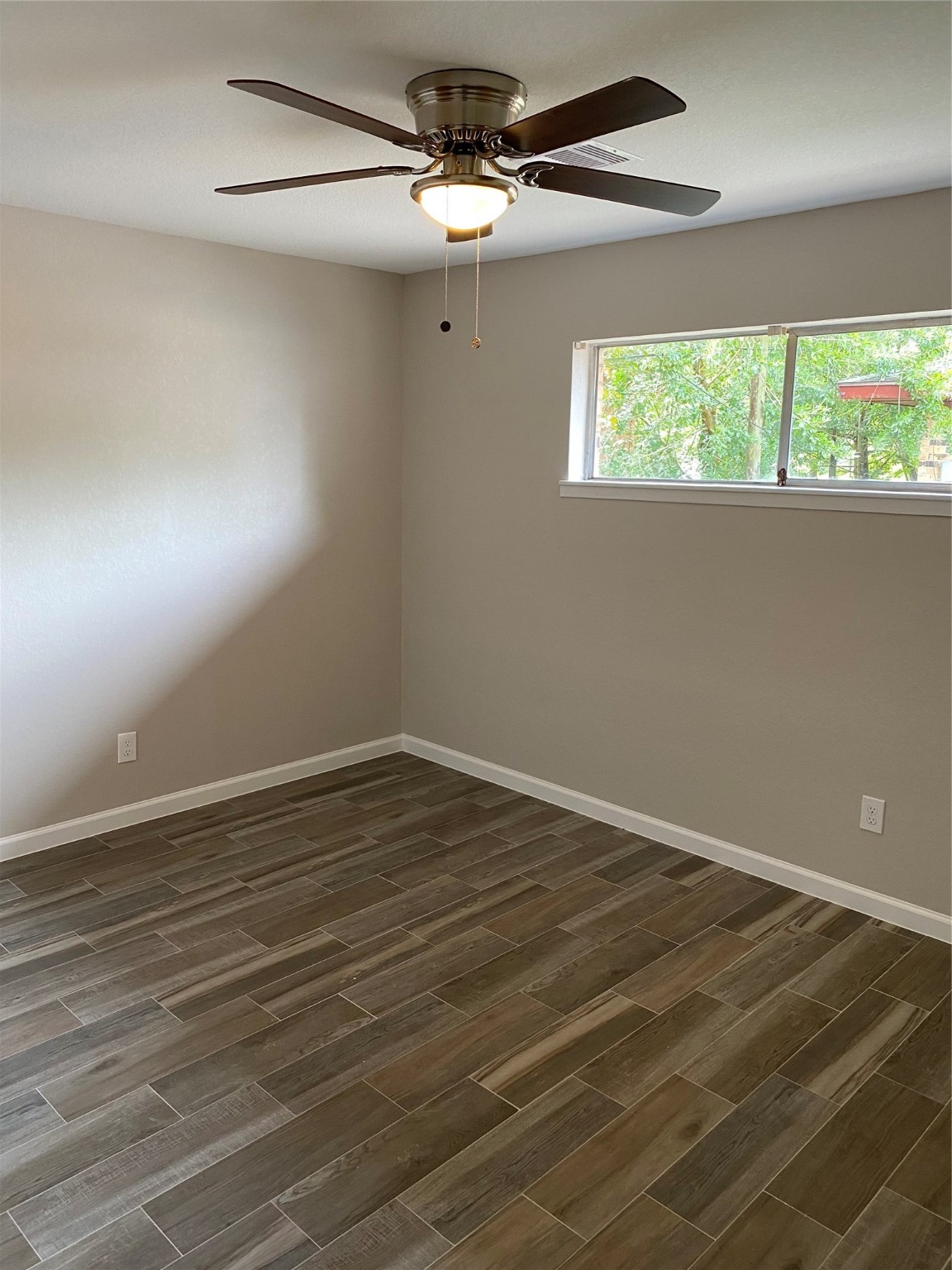 2922 Randolph Road Pasadena, TX 77503 - Photo 33 of 50 an empty room with wooden floor fan and windows