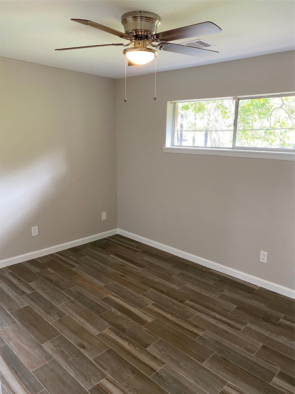 2922 Randolph Road Pasadena, TX 77503 - Photo 34 of 50 wooden floor in an empty room with a window