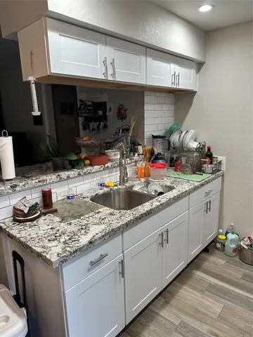 a utility room with stainless steel appliances and a refrigerator