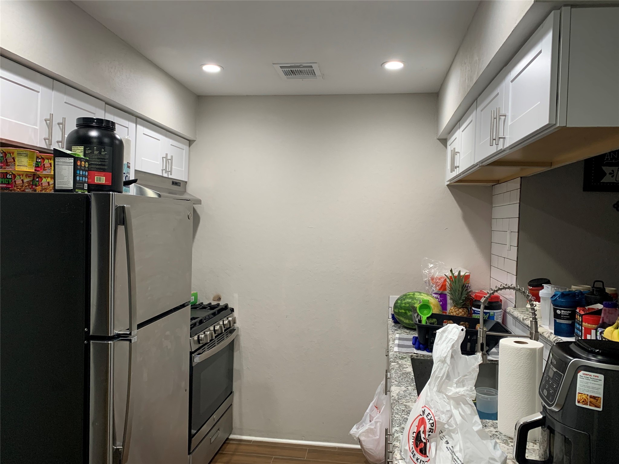 2922 Randolph Road Pasadena, TX 77503 - Photo 41 of 50 a kitchen with refrigerator and flowers