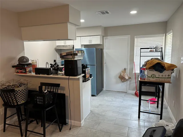 a kitchen with stainless steel appliances granite countertop a refrigerator and a sink