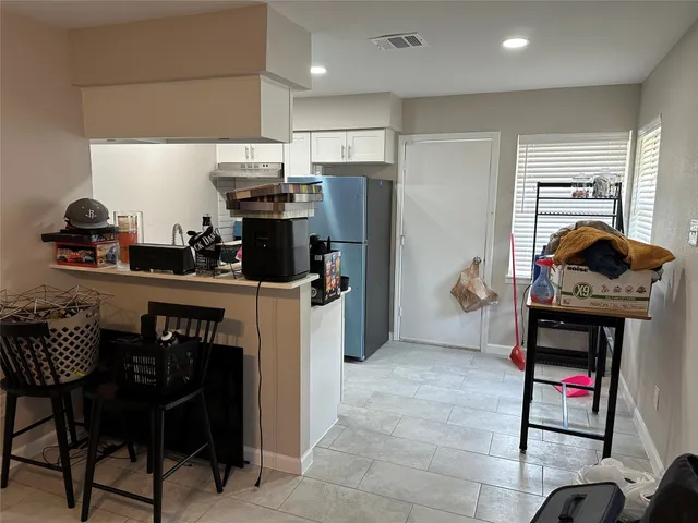 a kitchen with stainless steel appliances granite countertop a stove and a refrigerator