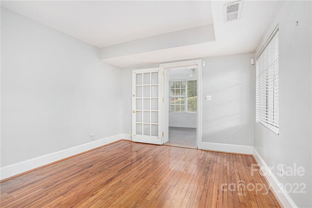 230 Providence Road Charlotte, NC 28207 - Photo 11 of 29 an empty room with wooden floor and windows