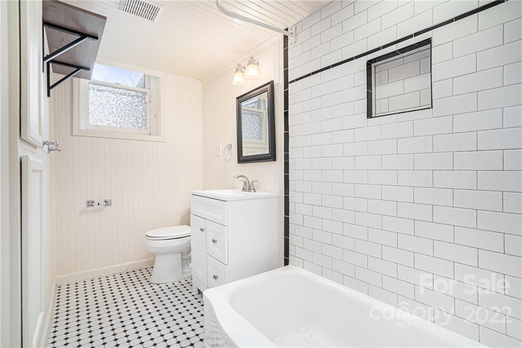 230 Providence Road Charlotte, NC 28207 - Photo 16 of 29 a bathroom with a toilet a sink a shower and a mirror