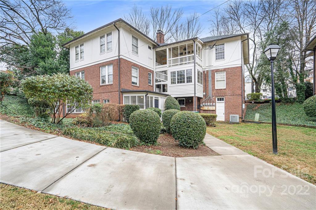 230 Providence Road Charlotte, NC 28207 - Photo 27 of 29 a view of a white house next to a yard with big trees