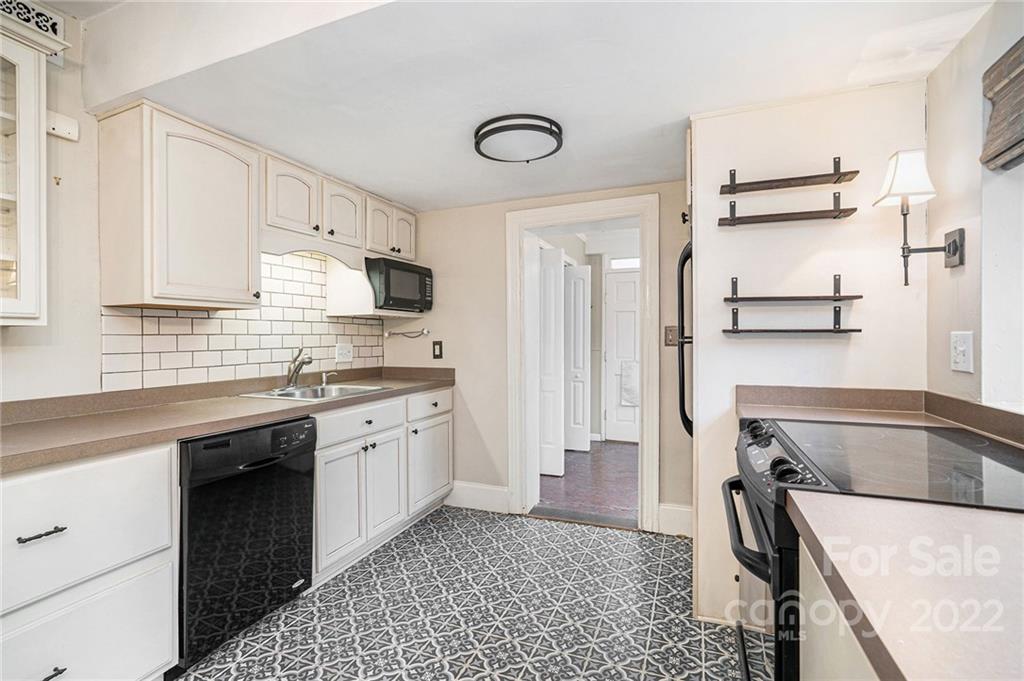 230 Providence Road Charlotte, NC 28207 - Photo 7 of 29 a kitchen with stainless steel appliances granite countertop a sink stove and refrigerator