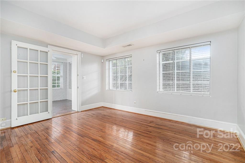 230 Providence Road Charlotte, NC 28207 - Photo 10 of 29 a view of an empty room with wooden floor and windows