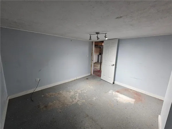 an empty room with a garage and a sink