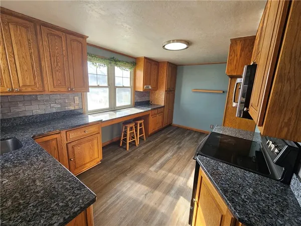 a kitchen with sink window and cabinets