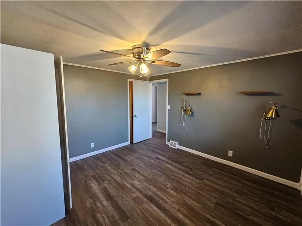 a view of an empty room with a fan