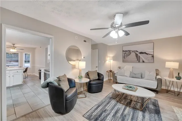 a living room with furniture a lamp and a chandelier