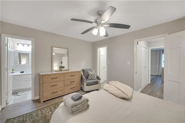 a bedroom with a bed and ceiling fan