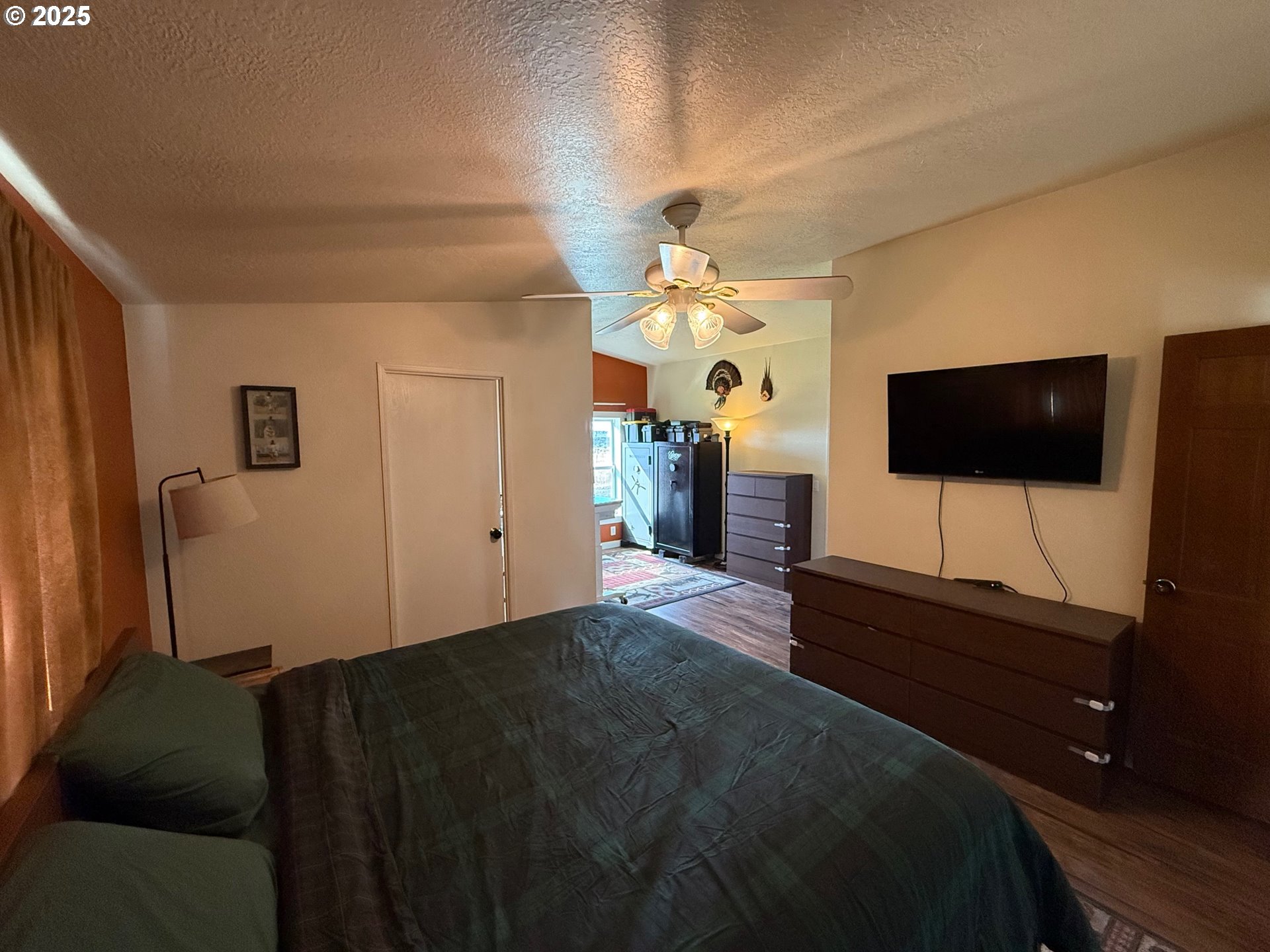 87479 North Star Lane Christmas Valley, OR 97641 - Photo 13 of 30 a living room with a bed furniture and a flat screen tv