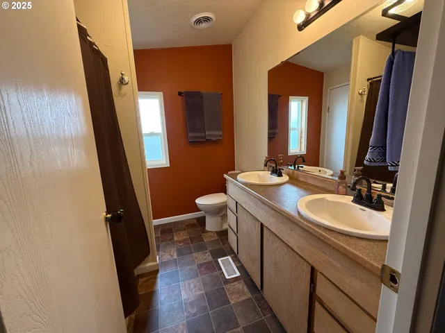 a bathroom with a double vanity sink and mirror