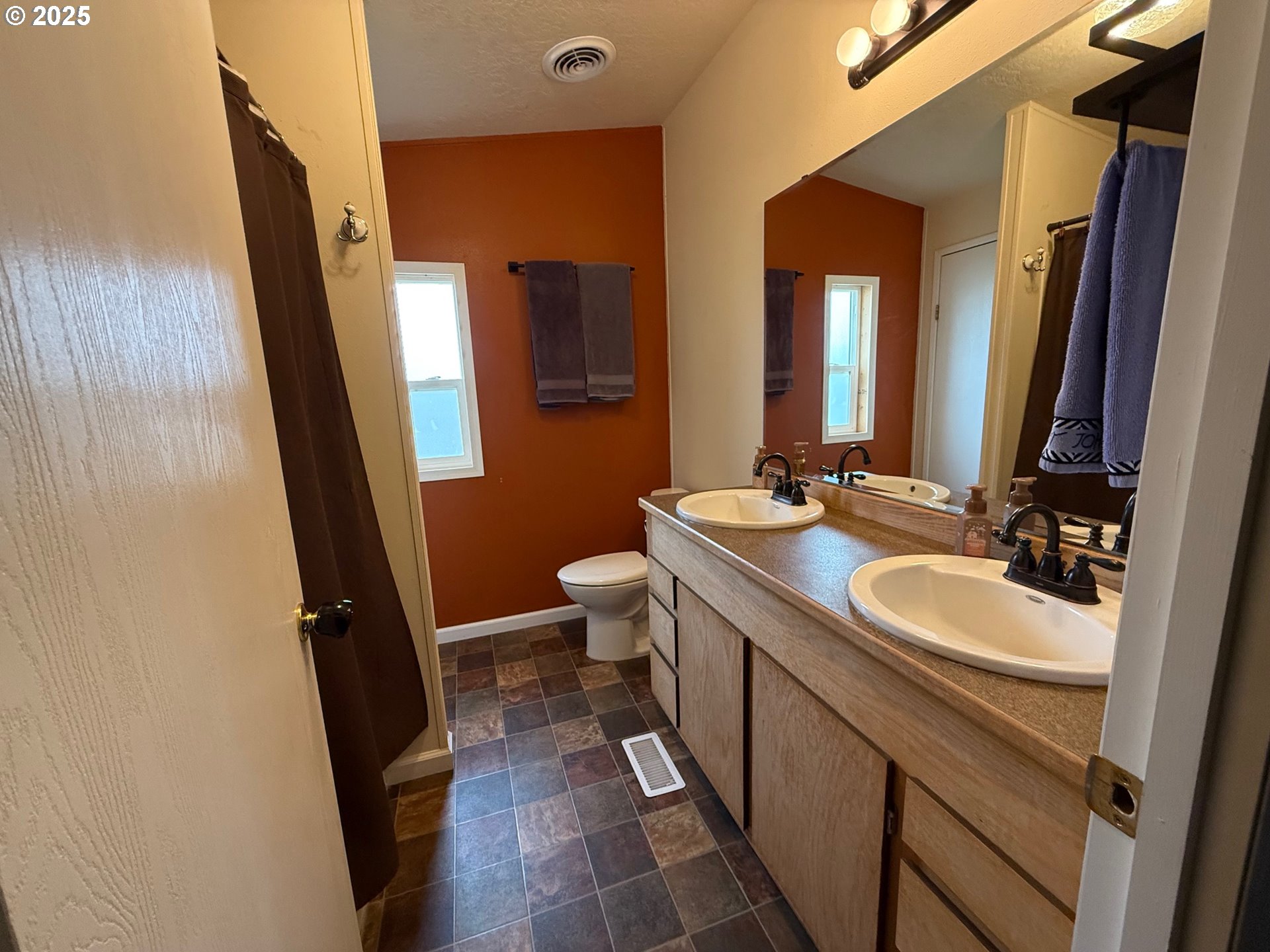 87479 North Star Lane Christmas Valley, OR 97641 - Photo 15 of 30 a bathroom with a double vanity sink and mirror