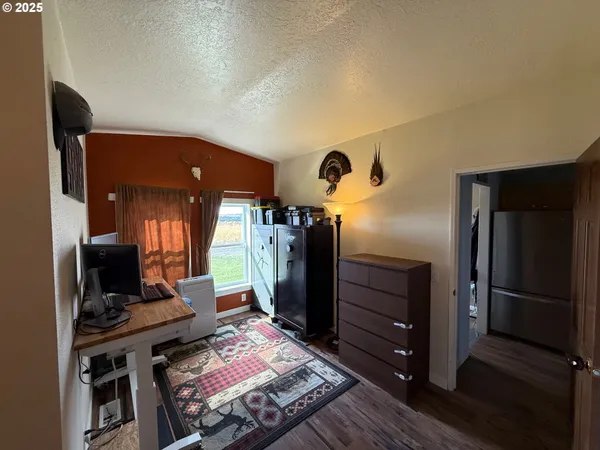 a kitchen with a refrigerator and a stove top oven