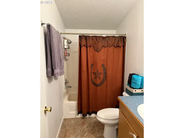 a bathroom with a shower toilet and sink