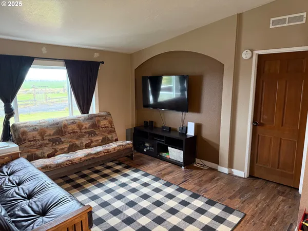 a bedroom with a bed and a television