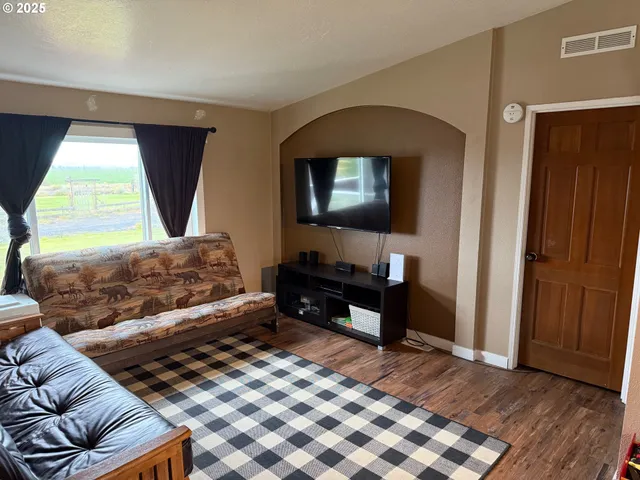 a bedroom with a bed and a television