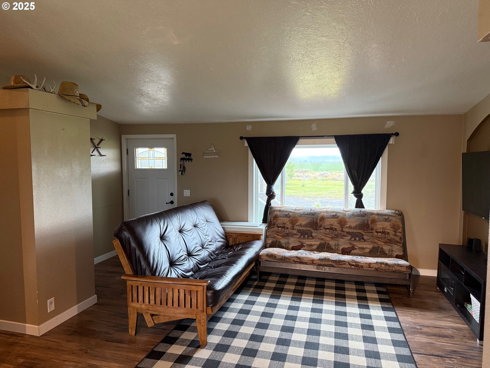 87479 North Star Lane Christmas Valley, OR 97641 - Photo 6 of 30 a bedroom with a bed and wooden floor