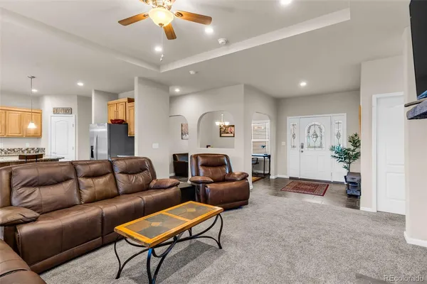 a living room with furniture and a chandelier