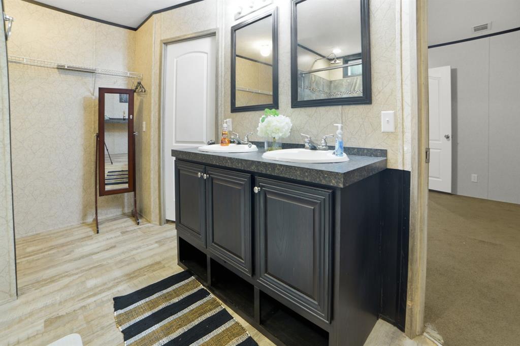 127 Almond Road Minden, LA 71055 - Photo 15 of 25 a bathroom with a granite countertop sink and a mirror