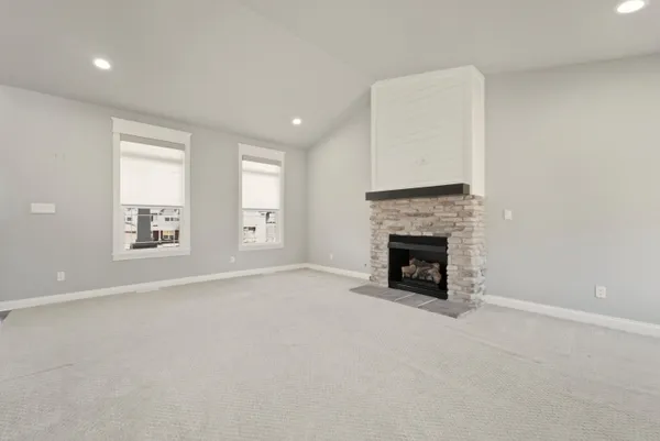 a view of a livingroom with a fireplace and window
