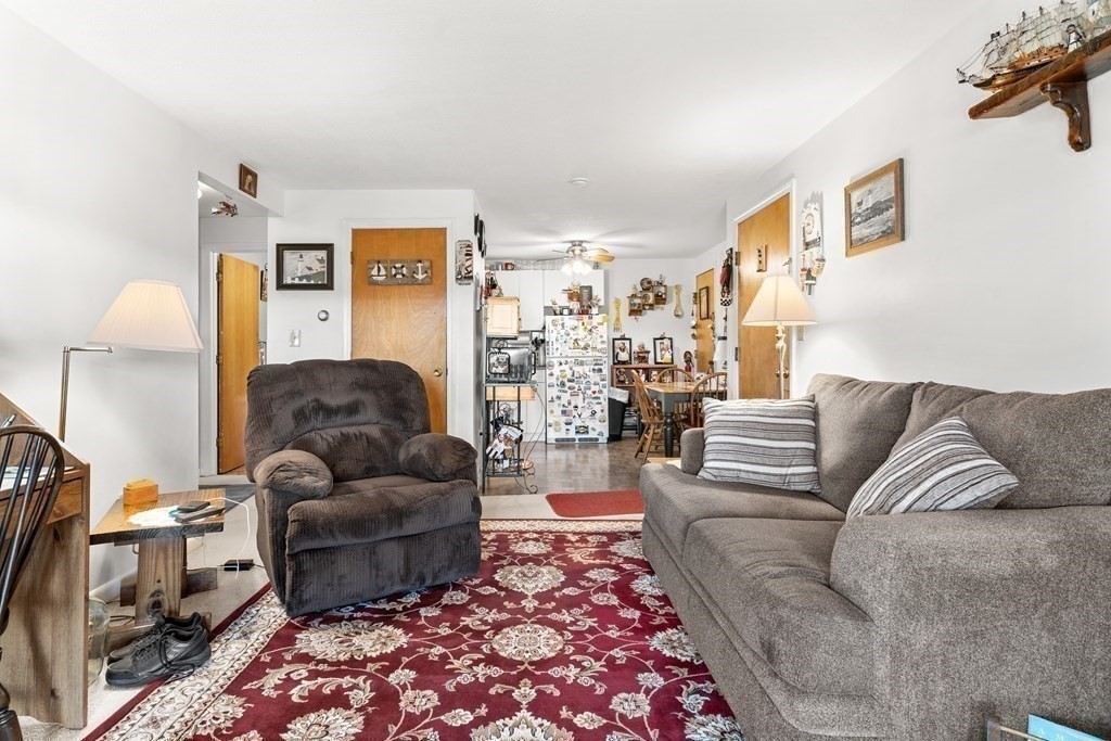 18 Woodman Way, Unit 17 Newburyport, MA 01950 - Photo 13 of 24 a living room with furniture and a couch