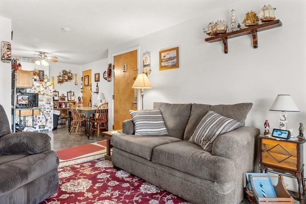 18 Woodman Way, Unit 17 Newburyport, MA 01950 - Photo 14 of 24 a living room with furniture and a lamp