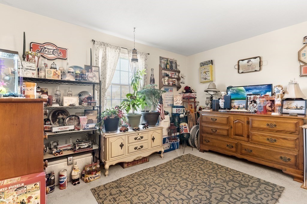 18 Woodman Way, Unit 17 Newburyport, MA 01950 - Photo 7 of 24 a bed room with a bed and a chair