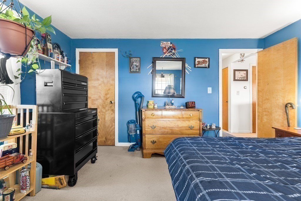 18 Woodman Way, Unit 17 Newburyport, MA 01950 - Photo 9 of 24 a bedroom with a bed and dresser