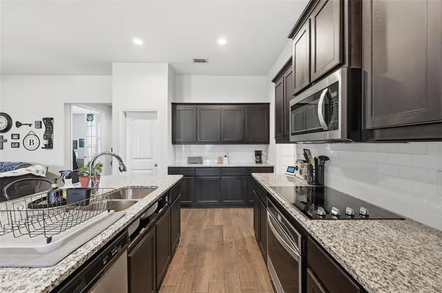 a view of a dining room with furniture wooden floor and chandelier