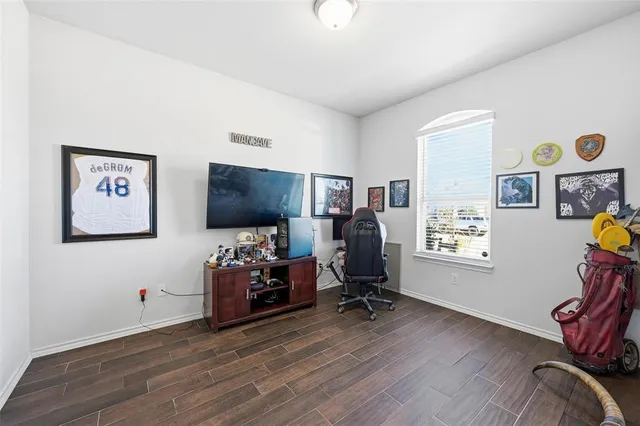 a view of a livingroom with workspace and a window