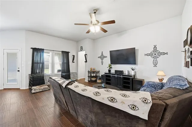 a living room with furniture and a flat screen tv