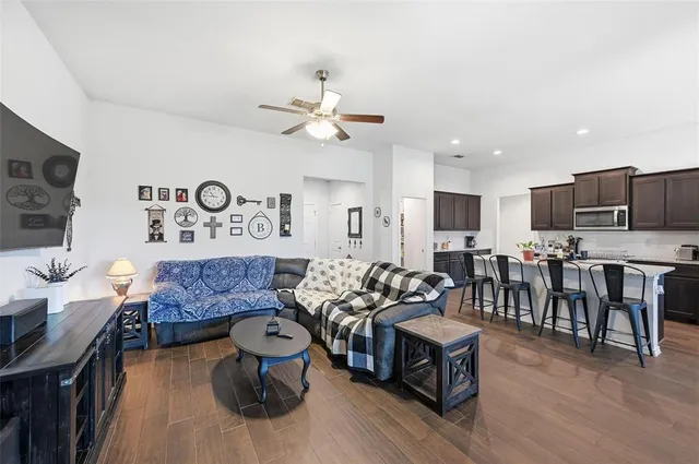 a living room with furniture and kitchen view