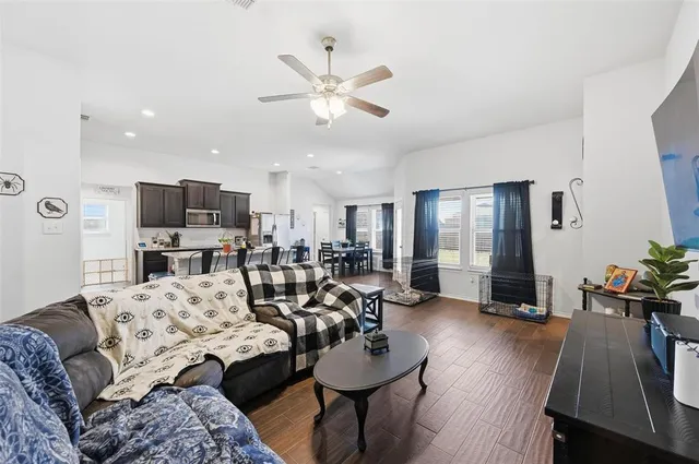a living room with furniture and wooden floor