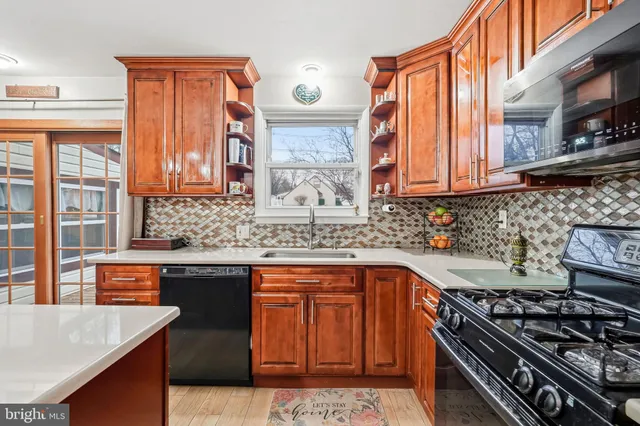 a kitchen with stainless steel appliances granite countertop a stove and a sink