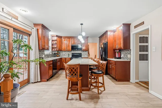 a large kitchen with a table and chairs