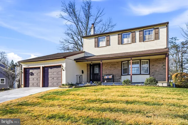 a view of a house with pool and chairs
